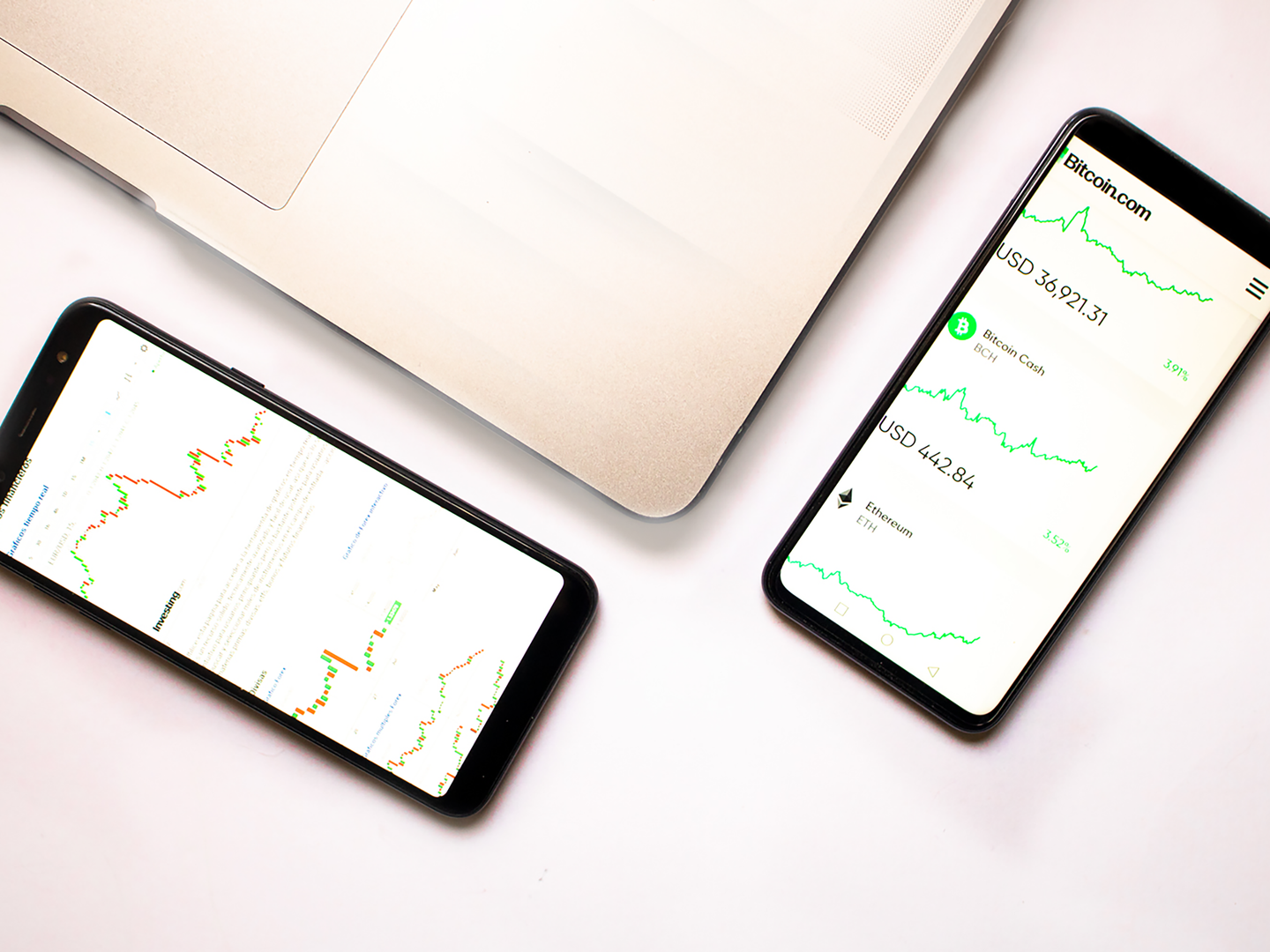 Two smartphones with cryptocurrency data and graphs, ideal for financial insights.